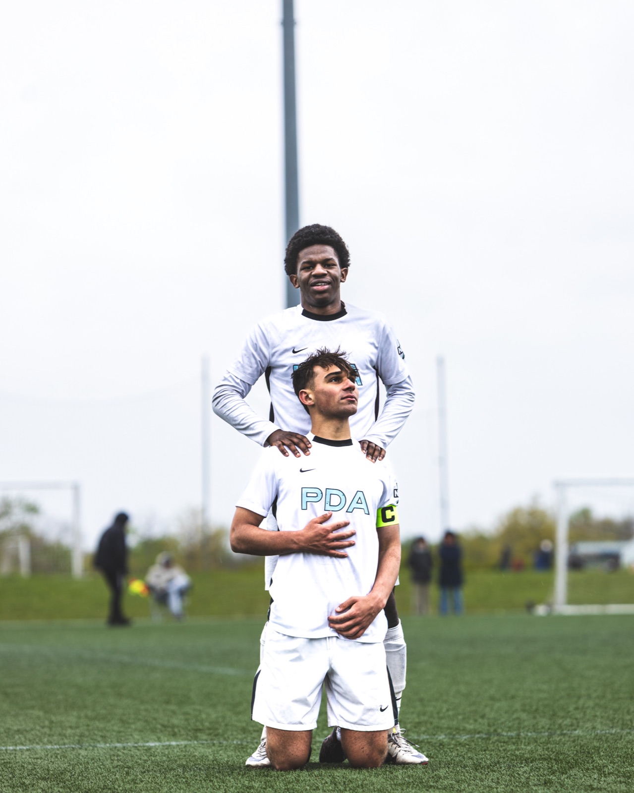 Two PDA soccer teammates posing together on the field